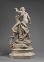 Back view of a marble sculpture of Fidelity crowning Love.  Love looks up at Fidelity who is el…