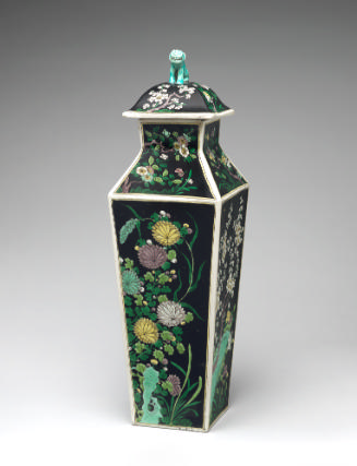 Porcelain square covered vase with black ground and floral and vegetal designs surmounted by a …