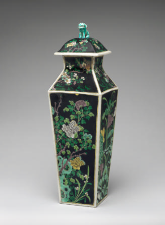 Porcelain square covered vase with black ground and floral and vegetal designs surmounted by a …