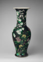 Alternate view of black ground porcelain vase with branches, leaves, rocks, and yellow and whit…