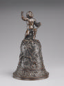 A bronze hand bell. The body of the hand bell is decorated with lively motifs, including pairs …