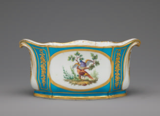 Porcelain oval dish in blue, white, and gold with birds