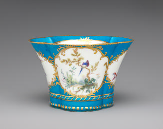 Porcelain four-lobed dish in blue, white, and gold with birds
