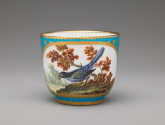 Porcelain cup in blue and gold with bird