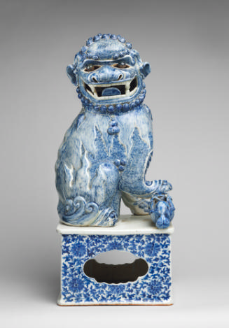 Blue and white porcelain dog sitting on intricately designed base