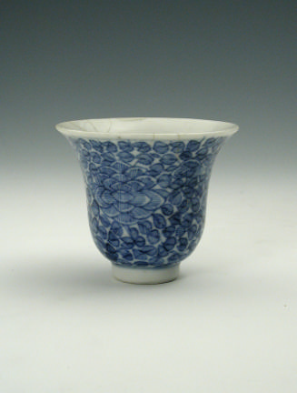White hard-paste porcelain wine cup with underglaze blue foliage decoration