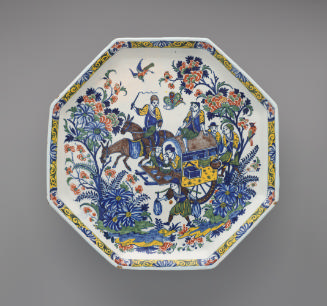 Top view of a footed platter with ornate floral and figurative decoration in color