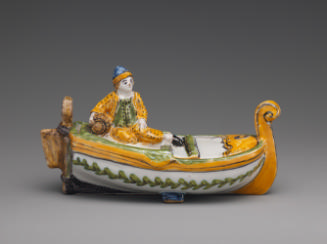 Spice box in the shape of a boat and fisherman painted in yellow and green