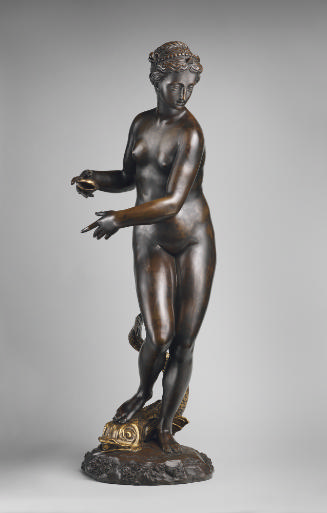 A bronze sculpture of a marine nymph.  She is in motion and her body is turned to the right.  S…