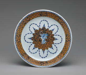 Circular plate with putti and a border of ornate yellow decoration