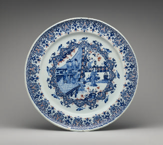 Large circular plate with oriental scene and ornate border in blue and red
