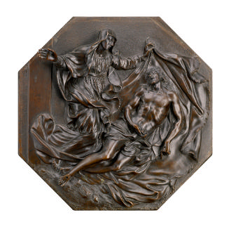Bronze octagonal relief sculpture of a pietà scene.   Jesus is seen lying to the right of the s…