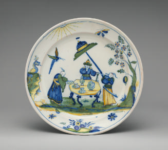 Circular plate with an oriental scene in blue, yellow and green