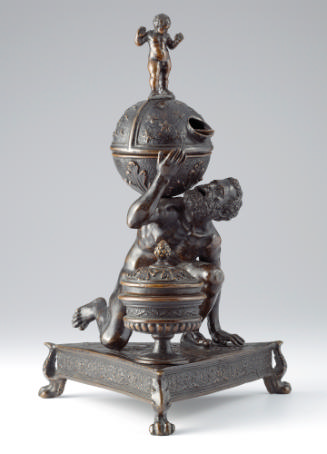 Bronze sculpture of crouching Atlas supporting globe with triangular base