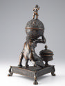 Bronze sculpture of crouching Atlas supporting globe with triangular base; back view