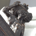 Detail of bronze sculpture of crouching Atlas supporting globe