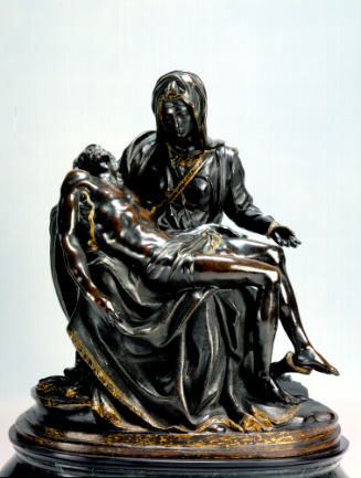 Bronze sculpture of a pietà scene.   The Madonna is seated with the deceased figure of Christ l…