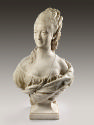Alternate view of a marble bust of Madame His.  She has long curly hair that is elaborately pin…