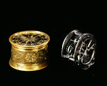 View of dismantled Portable Drum Clock with on the left the gilt-bronze case and on the right t…