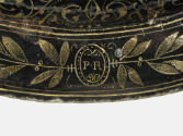 Detail of the decorative vegetal border with a medallion containing the letters P and R
