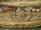 Detail of the mask in the tapestry on a Canapé: Part of a Set of Two Canapés, Eight Armchairs a…