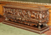 Side view of chest with draped figures decorating the angles