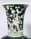 Alternate view of neck of vase, showing branches, white flowers, and patterned band