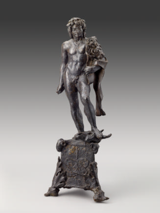 A bronze sculpture of Hercules.  He is looking straight ahead, with a lion's pelt draped on his…