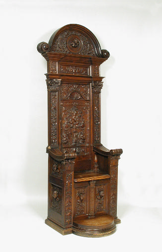Walnut armchair with high back and relief carving shpwing vegetal motifs and figural decoration