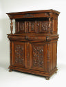 Walnut, pine, and oak cabinet with relief carvings of mythological figures and vegetal motifs
