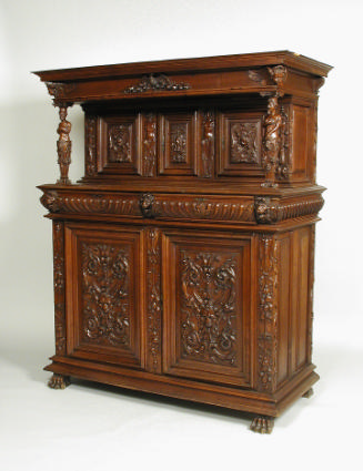 Walnut, pine, and oak cabinet with relief carvings of mythological figures and vegetal motifs