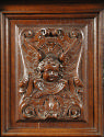 Detail of carved decoration from cabinet, showing head of cherub