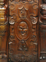 Detail of carved decoration from cabinet, showing mask