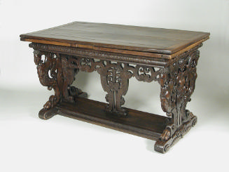 Walnut table with carved openwork supports