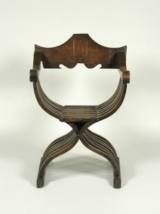 Walnut folding armchair with central shield