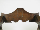 Detail of back of walnut folding armchair, showing shield