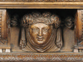 Draw-Top Center Table with Columnar Supports and Masks, detail of carved female face
