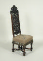 Walnut chair with openwork back and embroidered seat showing flowers, fruit, and insects
