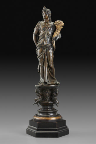 A bronze sculpture of a female figure with a cornucopia.  Her head is turned to her right and s…