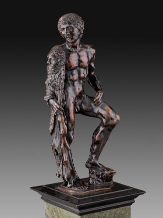 A bronze sculpture of Hercules.  His head is turned to his right and he has a lion's pelt drape…