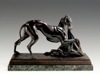 A bronze sculpture of a whippet.  The dog has a piece of cloth in its mouth and its right paw i…