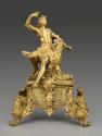 Gilt bronze andiron with male figure seated on the back of an eagle, with supports in the form …