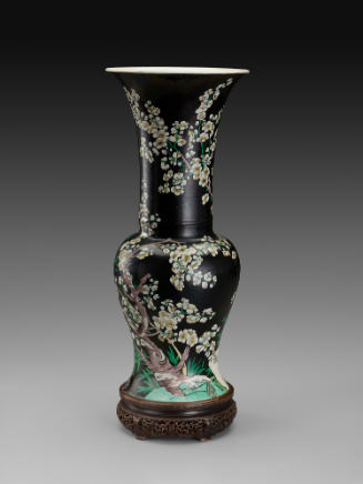 Black groundporcelain vase with branches, leaves, and white flowers