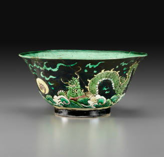 Porcelain bowl with flaring ring and black ground with dragon design