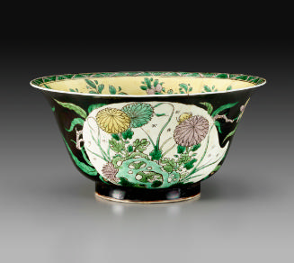 Porcelain bowl with flaring rim and black ground with vegetal designs