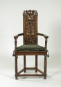 Armchair with Grotesque Reliefs and green cushion, frontal view 