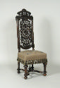 Walnut chair with openwork back and embroidered seat showing flowers, fruit, and insects