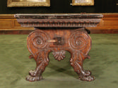 Alternate view of walnut table with supports in the form of scrolls and lion's-paw feet