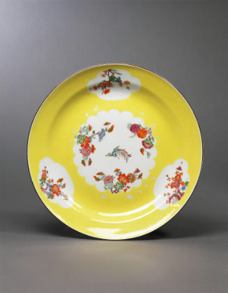 Image of plate with a light yellow ground and four cartouches with floral bouquets; the one in …