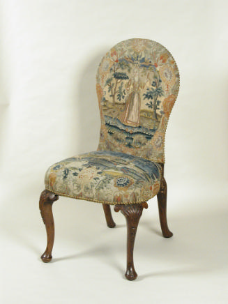 Chair with needlepoint upholstery showing woman standing outdoors, with birds and vegetal decor…